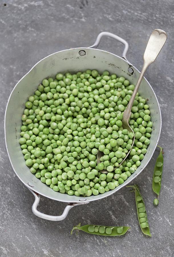 Lots Of Peas In An Old Saucepan With A Spoon Photograph by Adel Bekefi