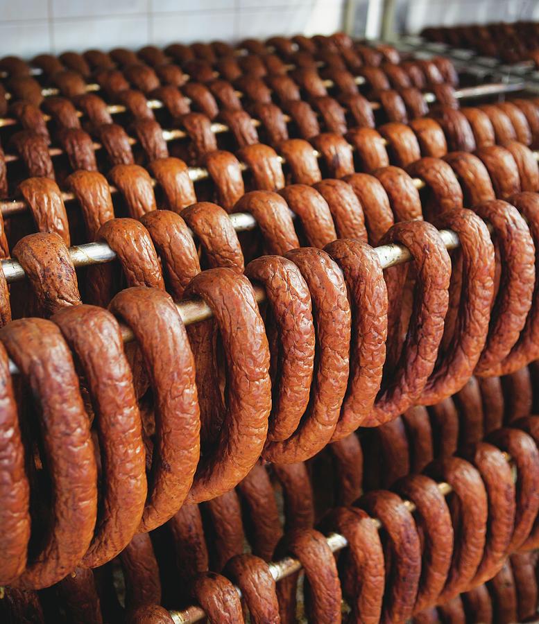 Lots Of Sausages Hanging On A Metal Rack Photograph by Pawel Worytko