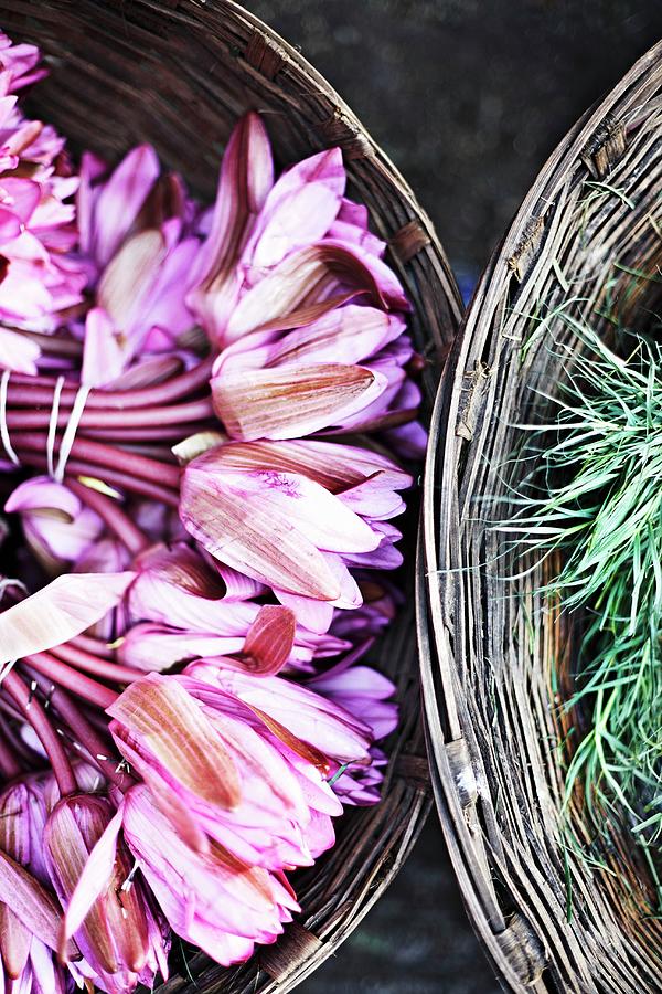 Lotus Flowers And Lemongrass In Baskets At A Flower Market In Mumbai, India Photograph by Ulf Svane