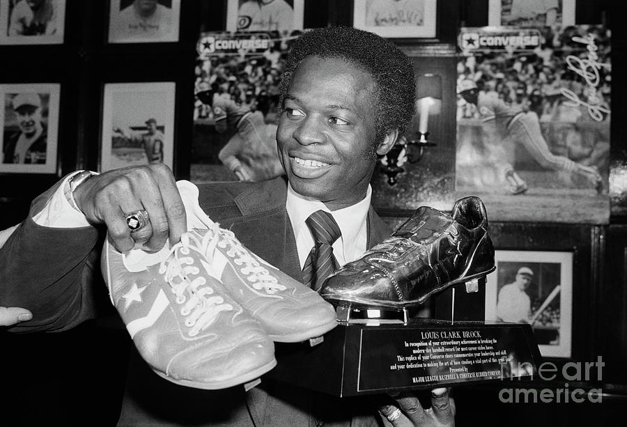 Lou Brock Holding Shoes And Shoe Trophy Photograph by Bettmann