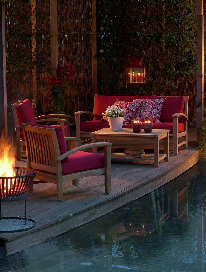 Lounge Furniture On Candlelit Terrace Next To Pool At Twilight Photograph by Werner Krauss