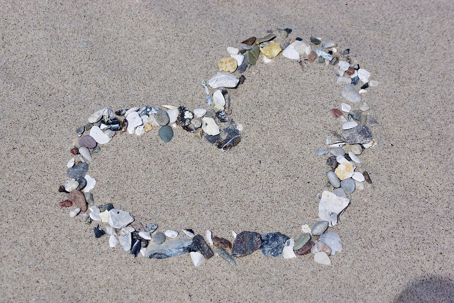 Love-heart Formed From Pebbles On Sand Photograph by Angelica Linnhoff