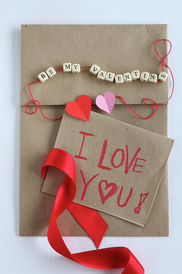 Love Note On Craft Paper And String Of Lettered Beads Photograph by Regina Hippel
