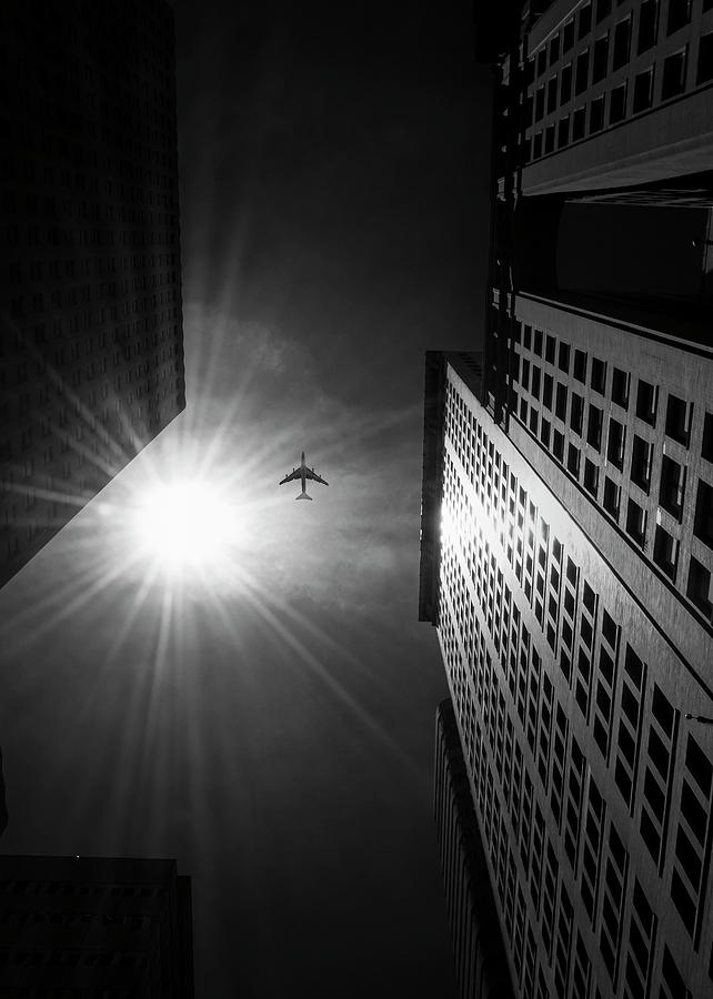 Low Angle Black And White Photo Of Airplane Flying In Manhattan Photograph