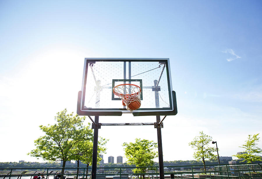 Nature Photograph - Low Angle View Of Ball In Basketball Hoop Against Sky by Cavan Images