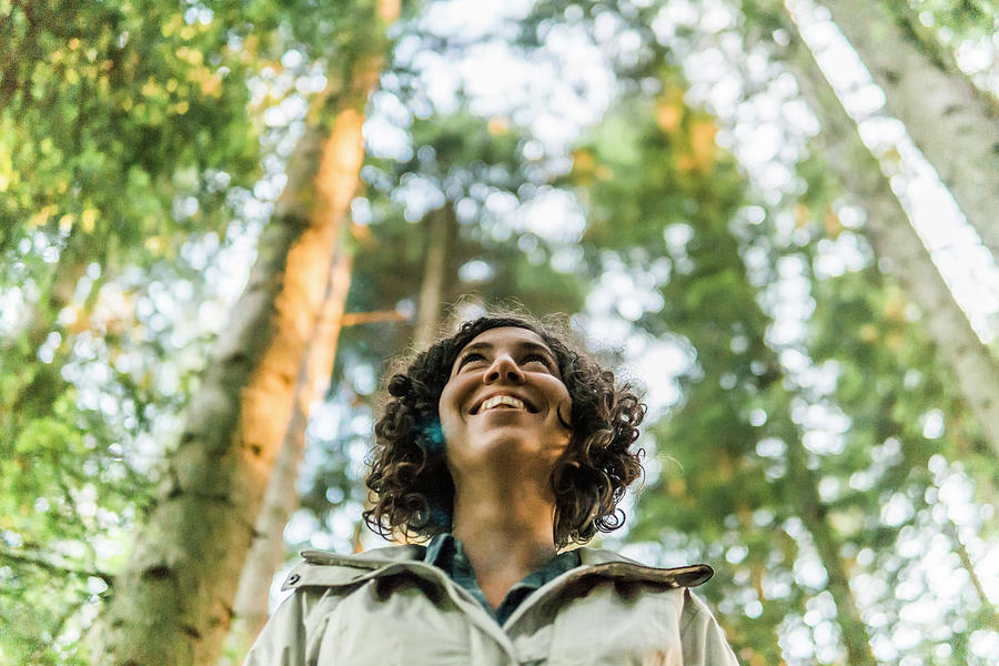Tree Photograph - Low Angle View Of Happy Woman Looking Away While Standing In Forest by Cavan Images