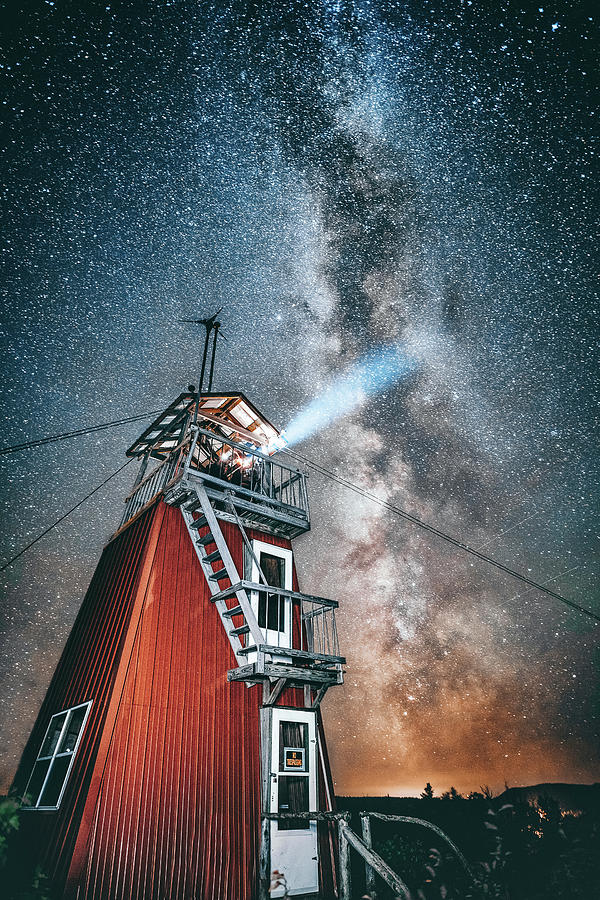 Nature Photograph - Low Angle View Of Light Emitting Through Lighthouse Against Starry Sky by Cavan Images