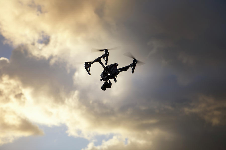 Low Angle View Of Quadcopter Flying Against Cloudy Sky Photograph by ...