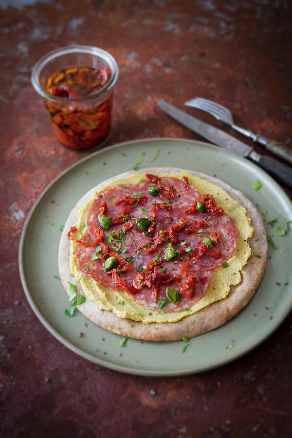 Low-carb Tarte Flambe With Hummus, Milan Salami And Dried Tomatoes Photograph by Jan Wischnewski