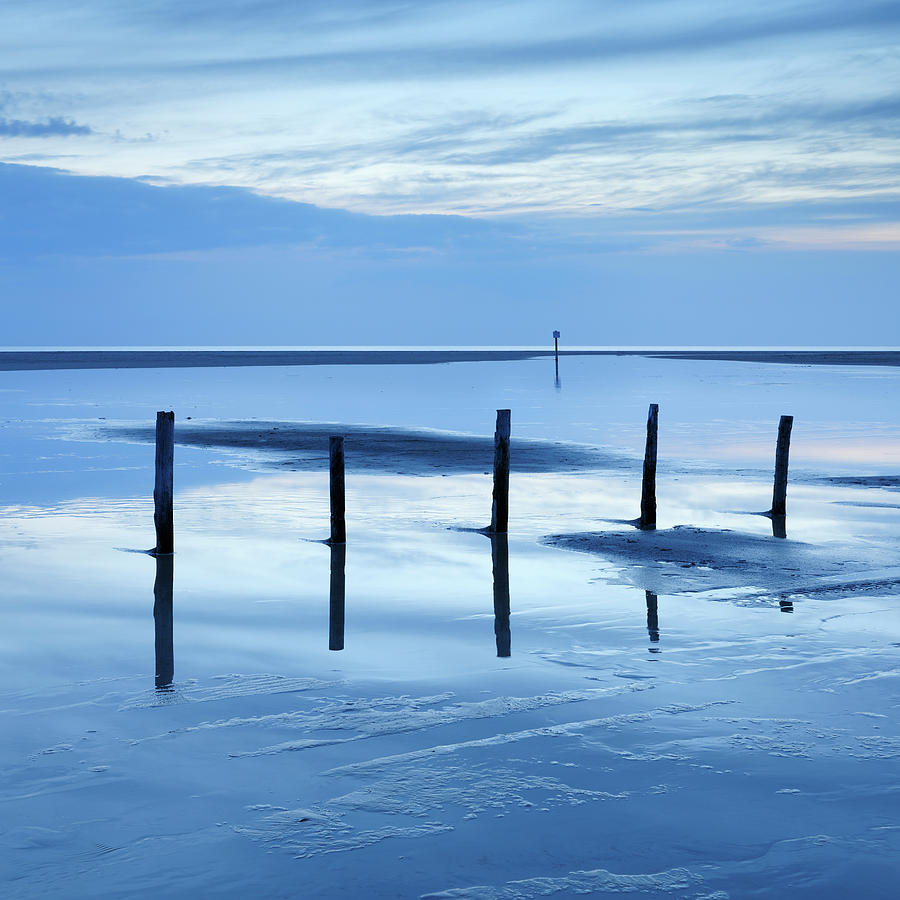 Low Tide Seascape With Wooden Posts In Photograph by Avtg
