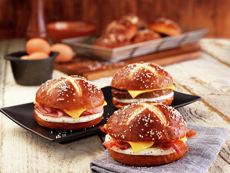 Lye Bread Rolls With Bacon, Cheese And Fried Egg Photograph by Jim Scherer