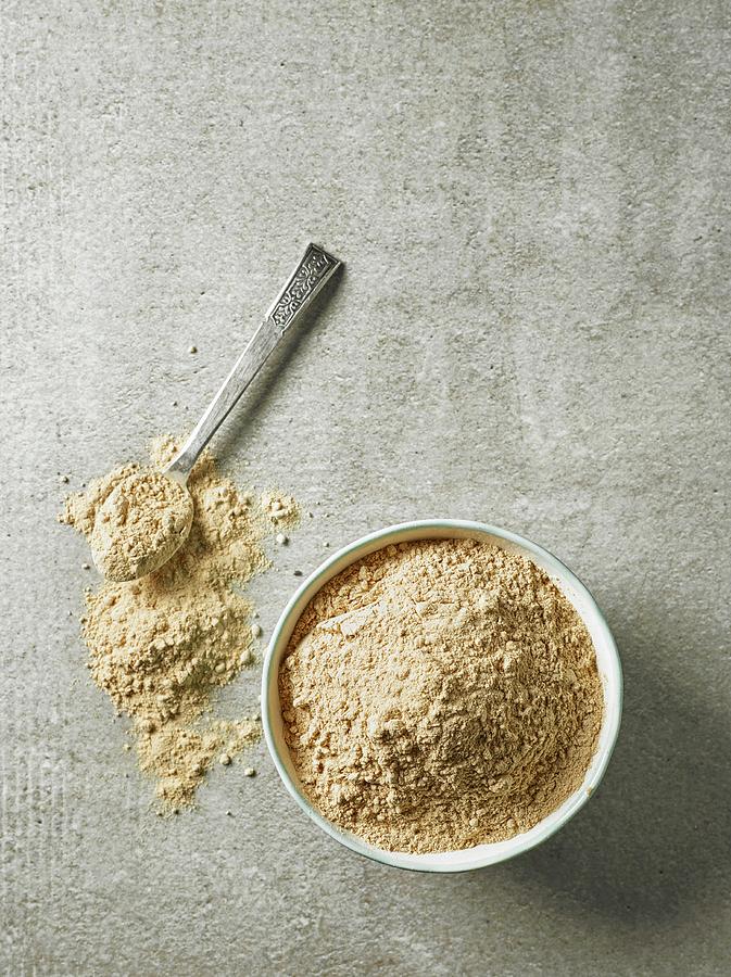 Maca Powder In A Bowl And On A Silver Spoon seen From Above Photograph by Maris Zemgalietis