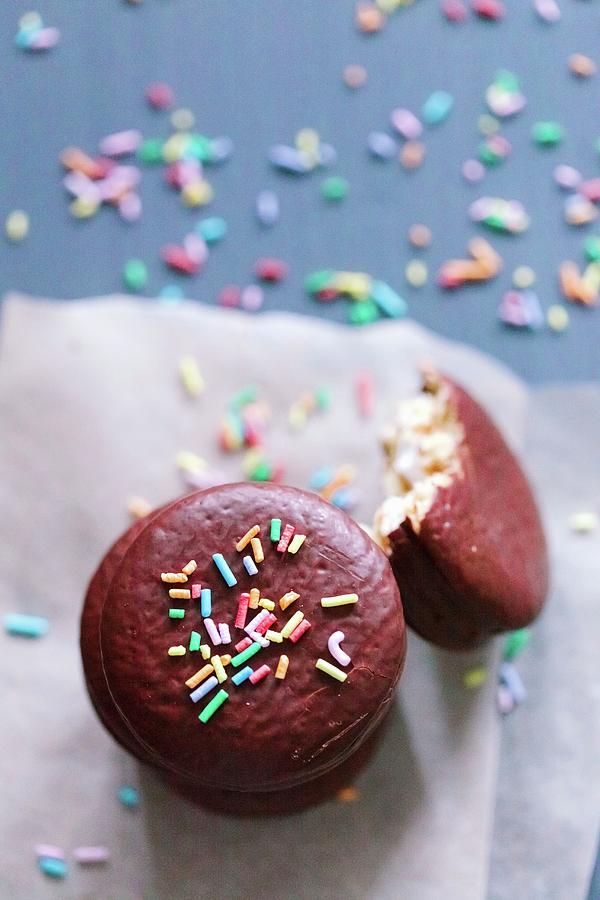 Macaroons In Chocolate Glaze With Candy Sprinkles Photograph by Sonya Baby