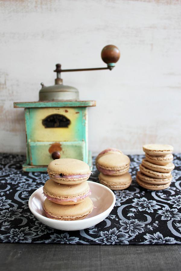 Macaroons In Front Of An Old Coffee Grinder Photograph by Patricia Miceli
