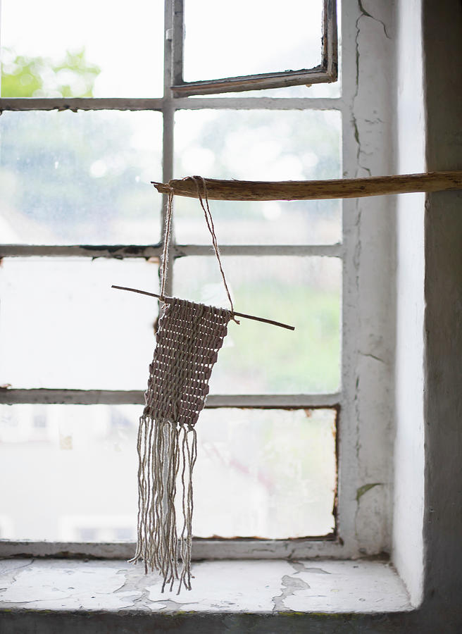 Macram Ornament Hung From Branch In Front Of Window Photograph by Alicja Koll