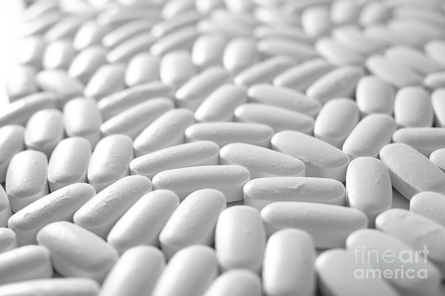 Macro close-up of many white pills, medication concept Photograph by Joaquin Corbalan