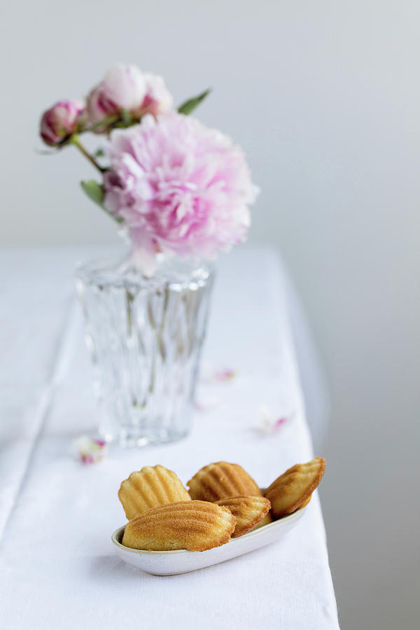 Madeleines In A Small Bowl In Front Of A Vase With Peonies Photograph by Jennifer Braun