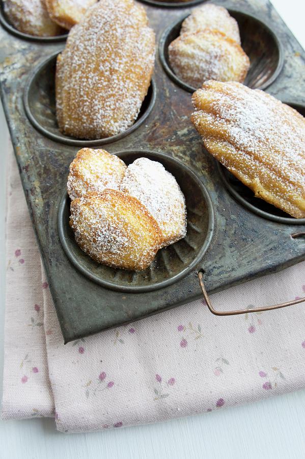 Madeleines In An Antique Baking Tray On A Floral Napkin Photograph by Schindler, Martina