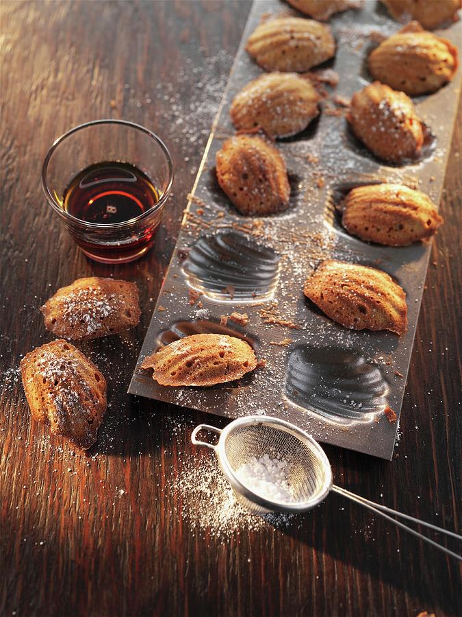 Madeleines With Icing Sugar In A Baking Tin Photograph by Manfred Jahrei