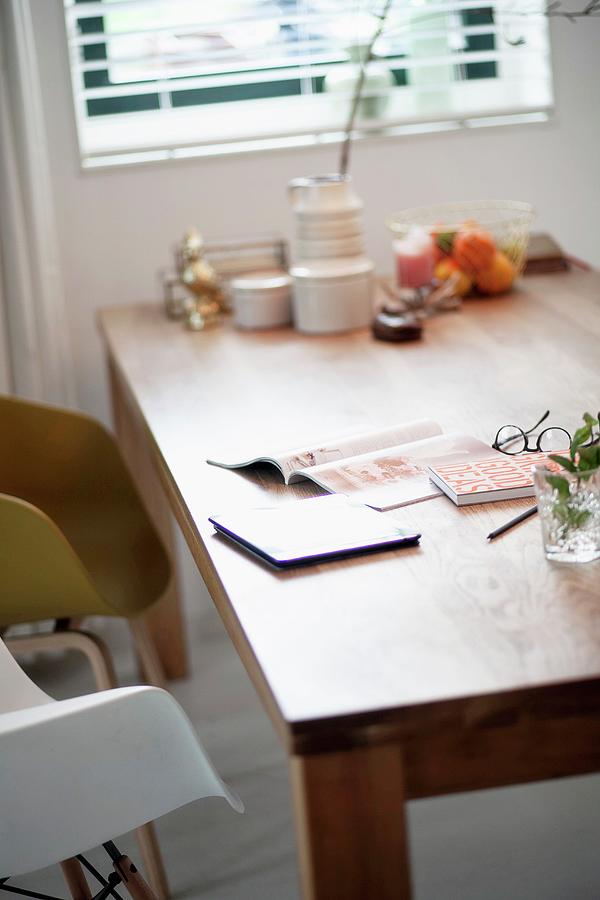 Magazine And Tablet On Wooden Dining Table Photograph by Heidi Fotografie