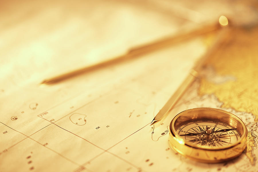 Magnetic And Drawing Compass On A Map Photograph by Neustockimages