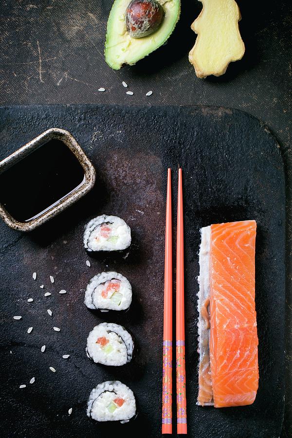 Maki Sushi With Salmon, Avocado, Ginger, Soy Sauce And Chopsticks Photograph by Natasha Breen