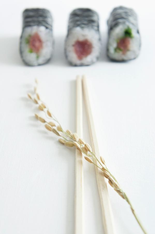 Maki Sushi With Tuna, Salmon And Cucumber, With An Ear Of Rice And Chopsticks Photograph by Martina Schindler