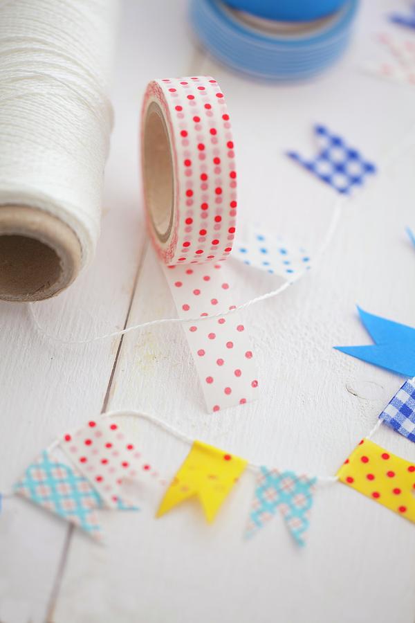 Making Decorative Flags With Masking Tape And String Photograph by Studio Lipov