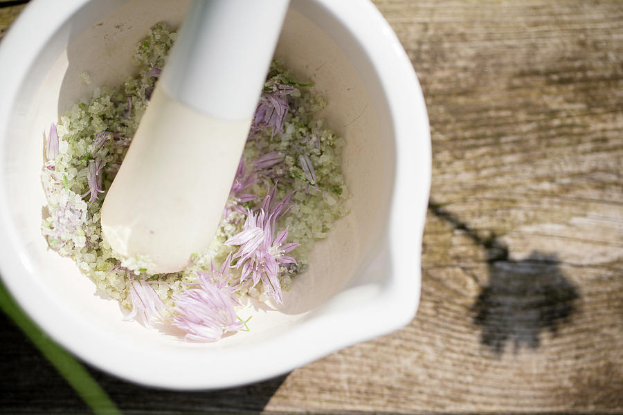 Making Homemade Chive-flower Salt: Grinding Flowers And Salt With Mortar And Pestle Photograph by Iris Wolf