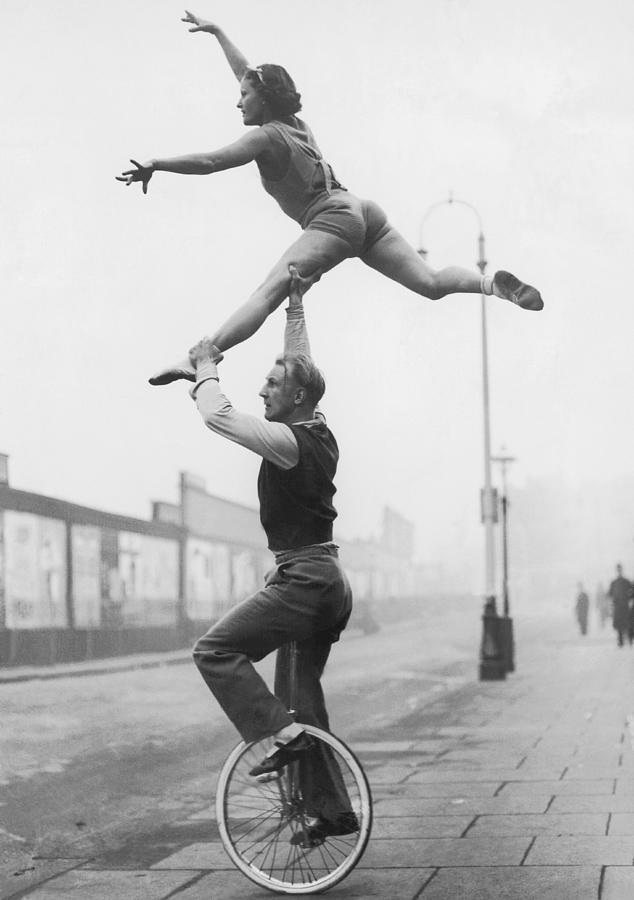 Male Acrobat On Unicycle Supporting Photograph by Fpg