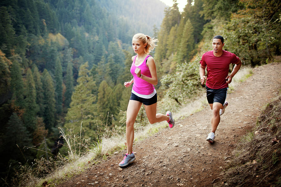 Male And Female Athlete Running On Mountain Photograph by Cavan Images ...