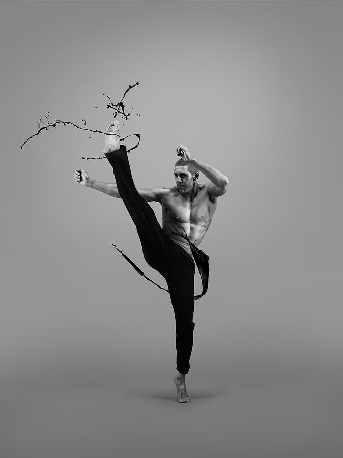 Male Athlete Kicking Liquid Splash Photograph by Jonathan Knowles ...