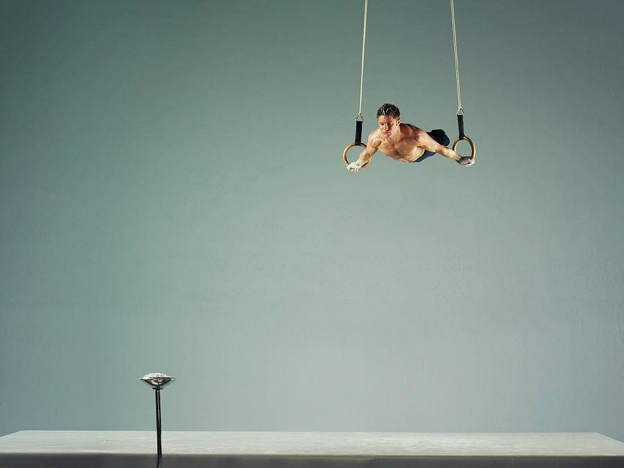 Male Athlete Practising A Rings Exercise Photograph by 10000 Hours