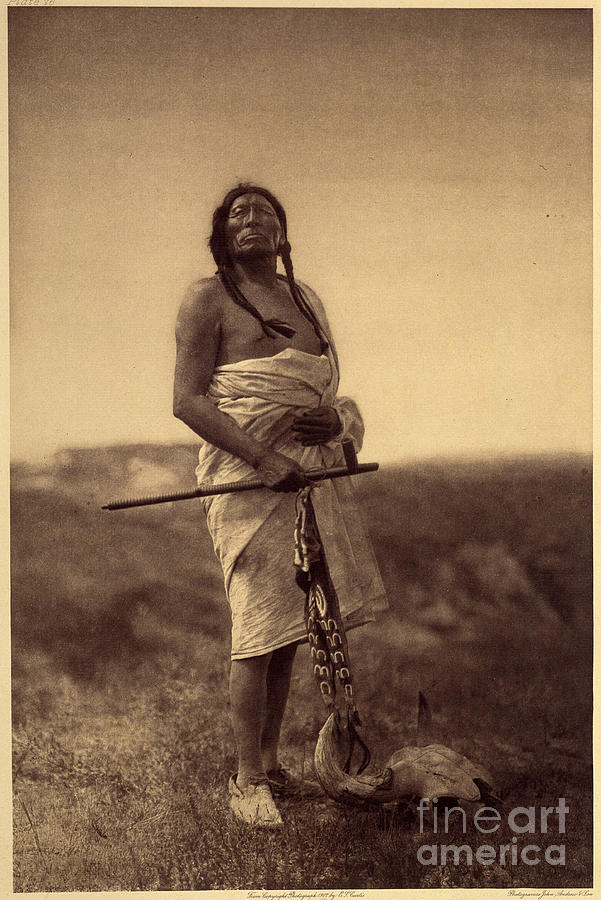 Male Doctor. Probably Sioux, Squid In Hand And Buffalo Skull Has His Feet. Photo Taken From Volume 3 Of Edward S. Curtiss Encyclopedia Photograph by Edward Sheriff Curtis