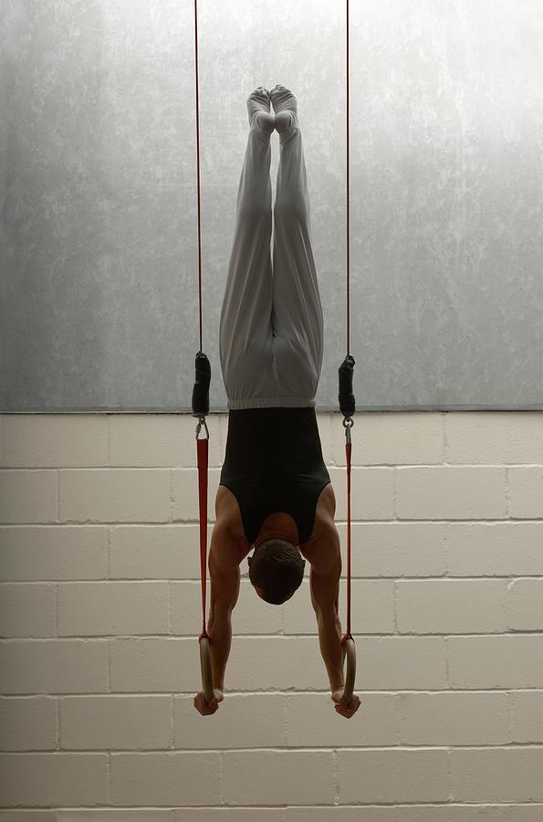 Male Gymnast Balancing Upside Down On Photograph by Romilly Lockyer