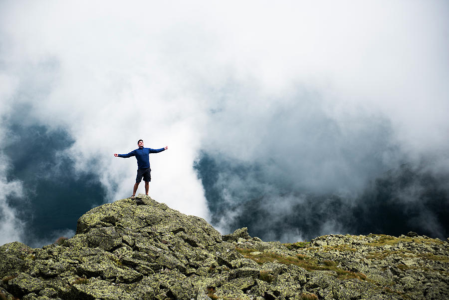 Male Hiker Enjoying The Sun In The Mountains With Clouds Behind ...