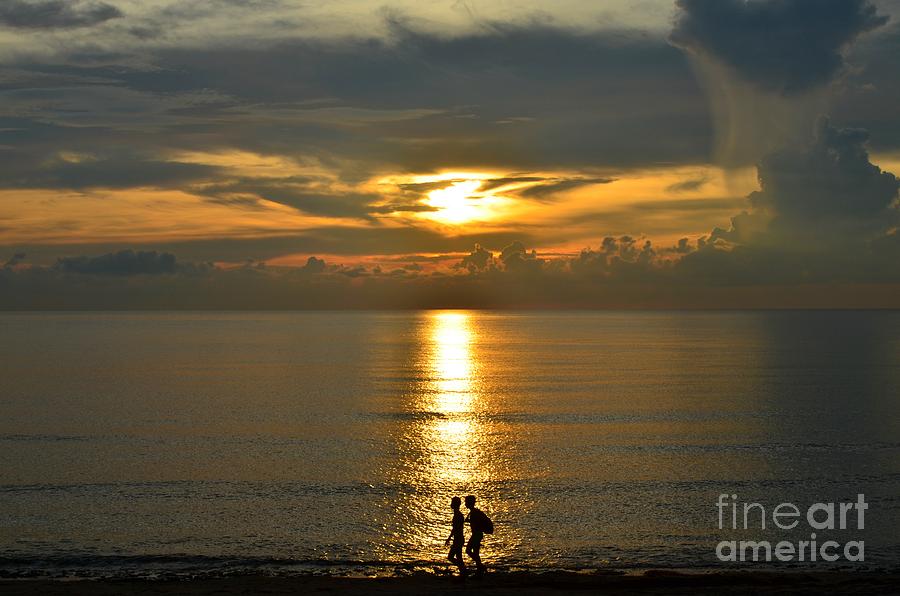 Male Swimmers walking along the sunset in photograph by Christopher Shellhammer Male Swimmers walking along the sunset in photograph by Christopher Shellhammer