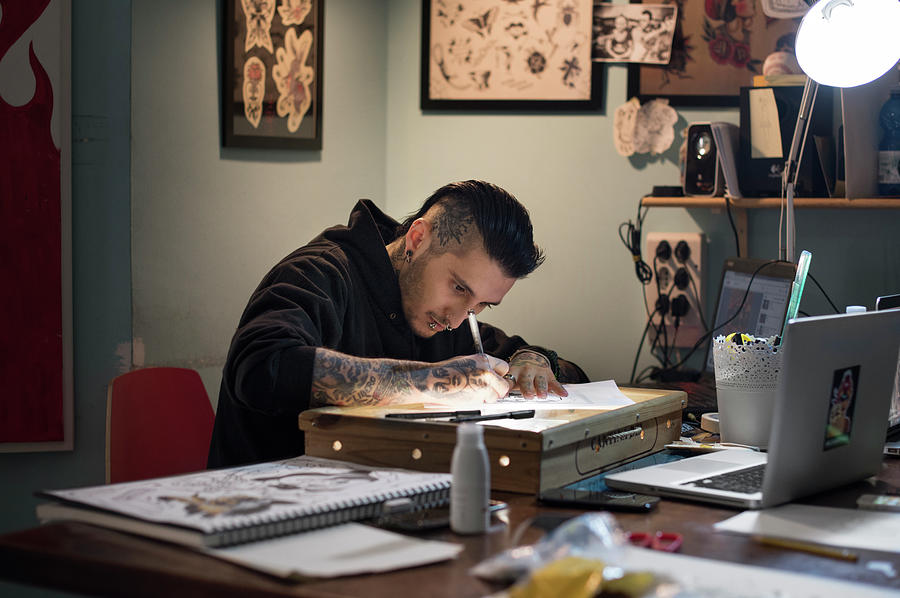 Male Tattoo Artist Drawing On Paper In Studio Photograph by Cavan ...