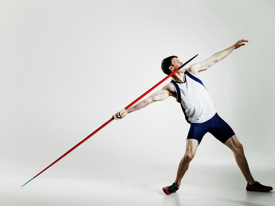 Male Track Athlete Preparing To Throw Photograph by Thomas Barwick Male Track Athlete Preparing To Throw Photograph by Thomas Barwick