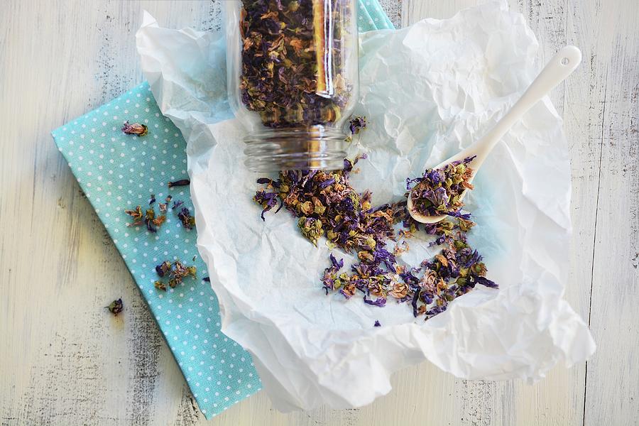 Mallow Tea In A Glass Jar And Spread Out On Paper Photograph by Mariola Streim
