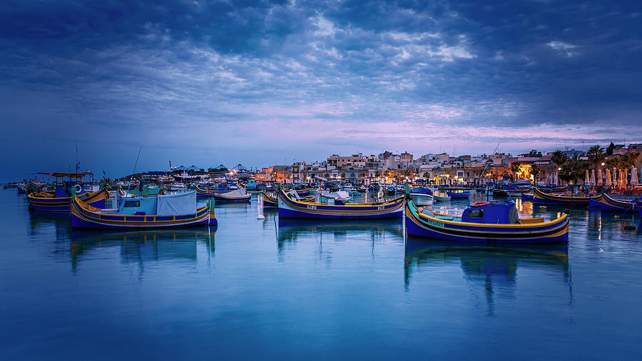 Malta, Marsaxlokk, Mediterranean Sea, Luzzu, Traditional Fishing Boats And Marsaxlokk Harbor At Dusk Digital Art by Alessandro Saffo