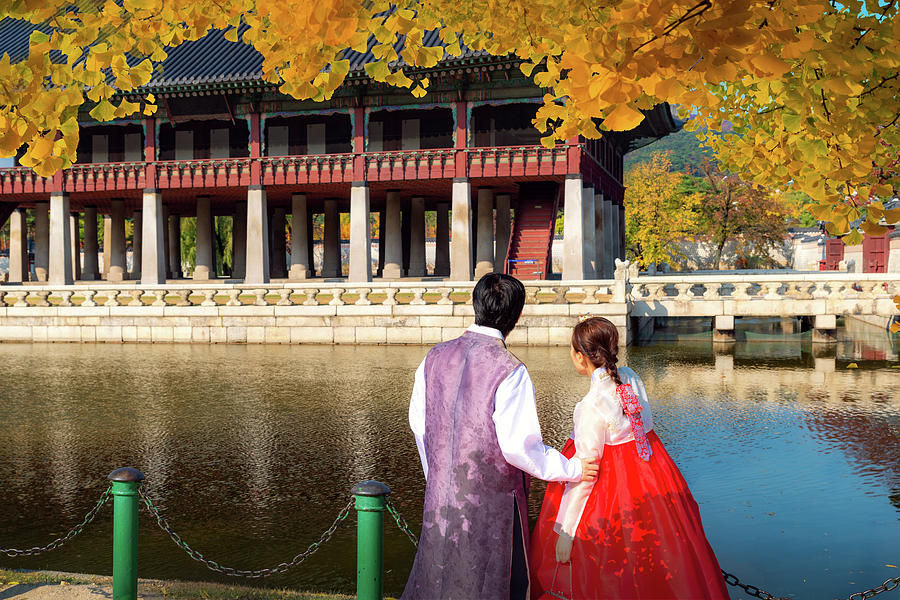 Man and Lady in hanbok dress walk in seoul palace in ginkgo autu Photograph by Anek Suwannaphoom