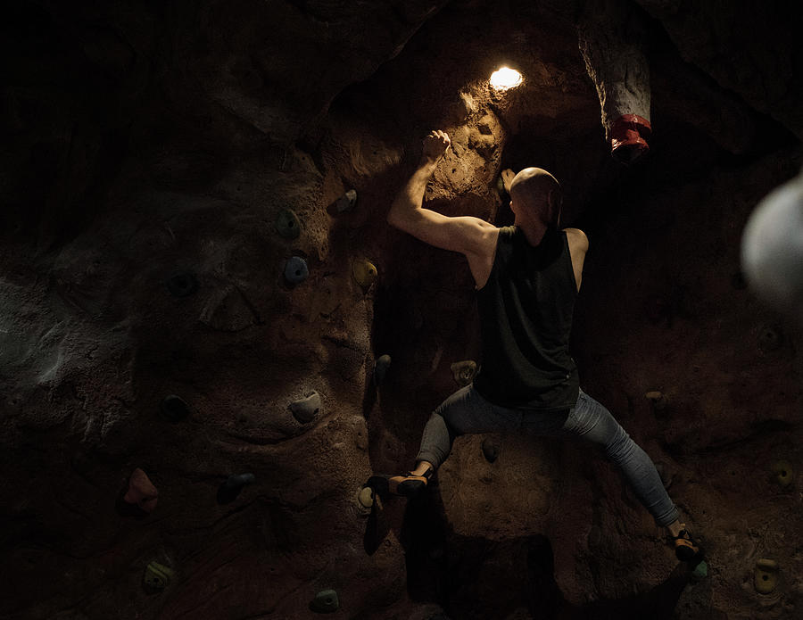 Man At The Top Of A Bouldering Wall Photograph By Cavan Images Fine Art America