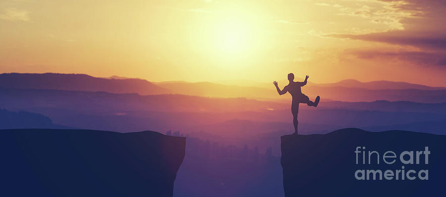 Man balancing on the edge of a cliff. Photograph by Michal Bednarek