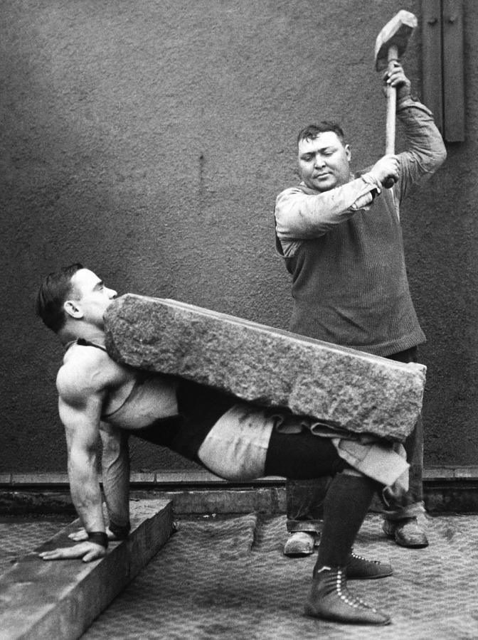 Man Crushing With A Hammer A Rock Block Photograph by Keystone-france
