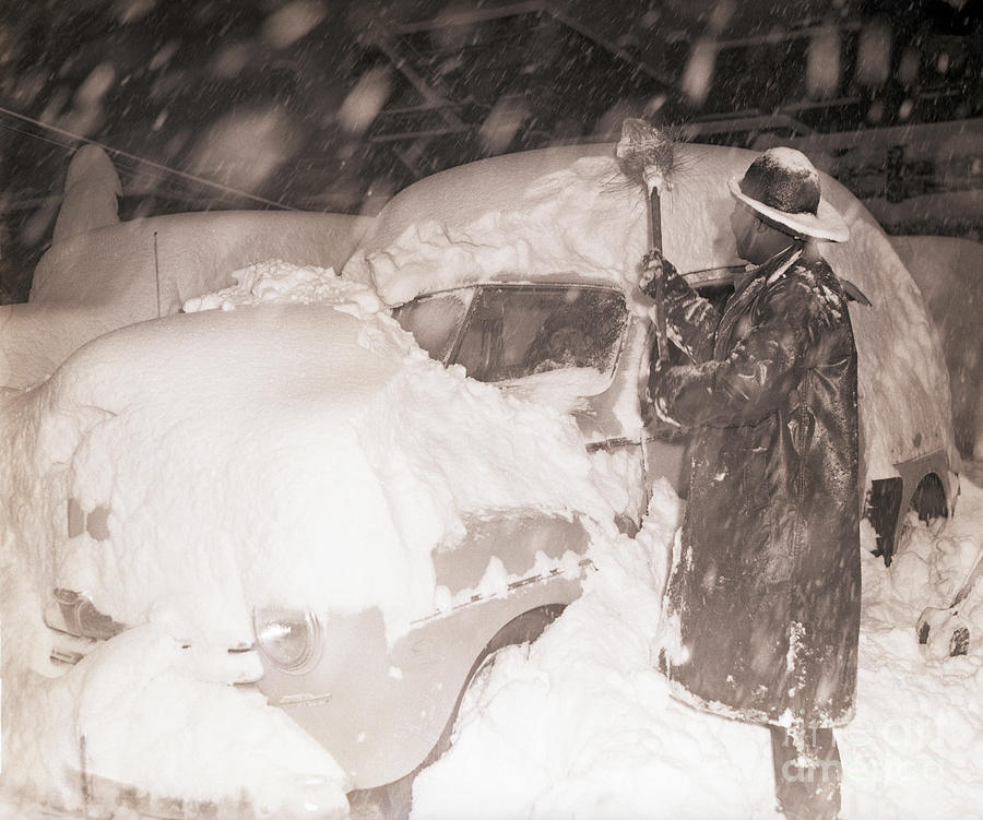 Man Digging Automobile Out Of Snow Photograph by Bettmann