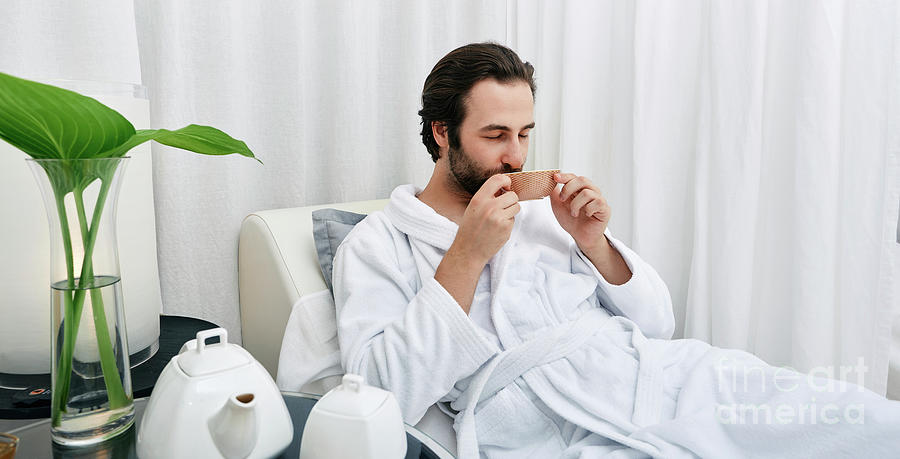 Man Drinking Tea At A Spa Photograph by Peakstock / Science Photo Library