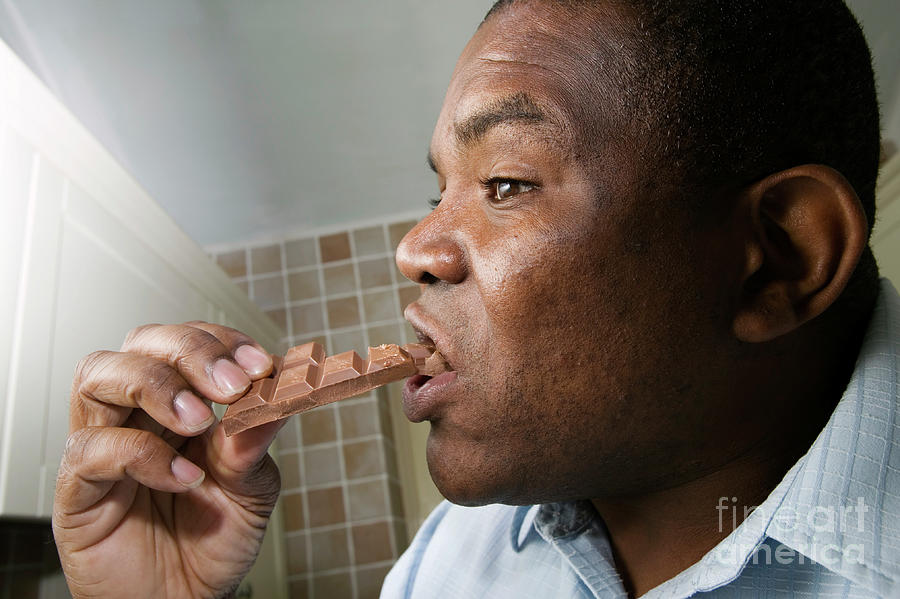 Man Eating A Bar Of Chocolate Photograph by Samuel Ashfield/science