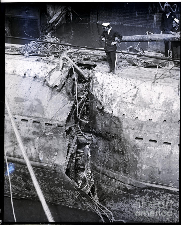 Man Examining Hole Ripped In Hull Photograph by Bettmann