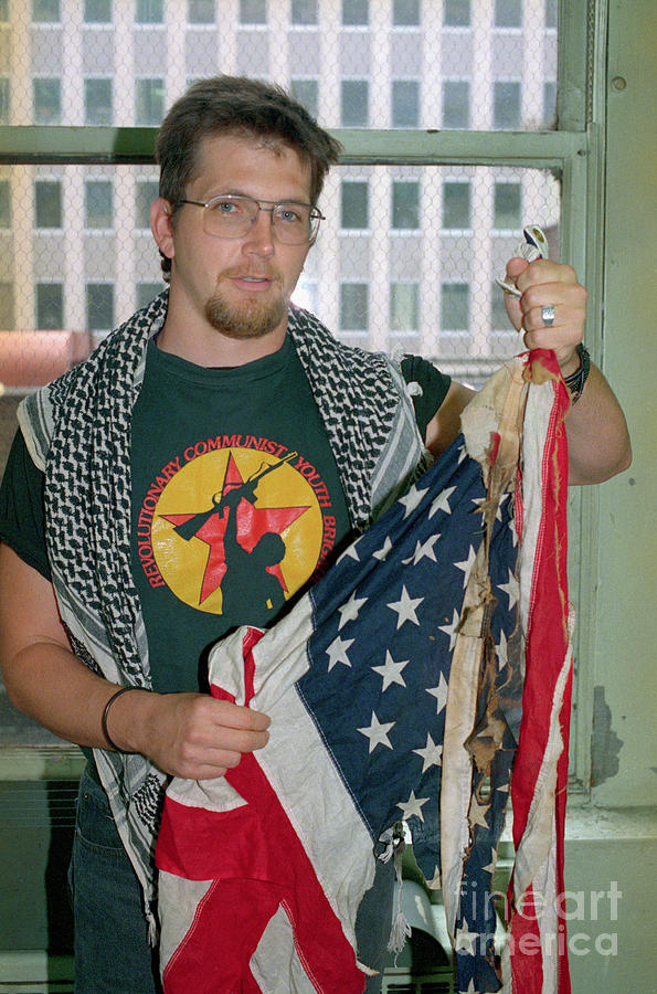 Man Holding Burned American Flag Photograph by Bettmann